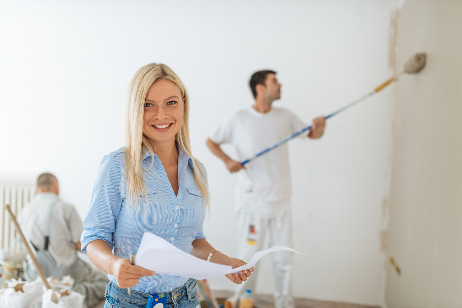 Cheerful property manager with painters